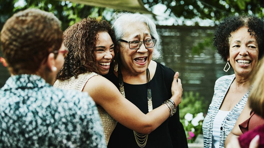 Daughter hugs elderly mother in a family reunion