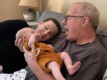 Family holding a baby